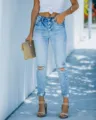 High-waisted multi-button ripped skinny jeans detail, showing distressed knee and rolled cuff. - S / Light Blue