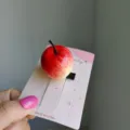 Adorable realistic 3D red apple hair clip on pink display card for women and girls - 2 Pieces/Pack / Sand Apple