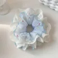 Elegant white lace scrunchie featuring light blue pleated fabric with colorful dots - Blue Lace