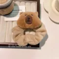 Cute cartoon plush Capybara scrunchie for hair styling in soft beige and brown tones - Scrunchie / Brown
