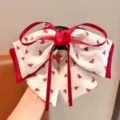 Detailed macro view of the sweet red and white layered bow hair claw clip for girls - Red White Bow