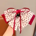 Close-up of double-layered hair claw clip with red floral print and ribbon bow detail - Red & White Flower