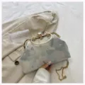 Close-up of elegant floral jacquard evening clutch with gold-tone crystal clasp - Sky Blue