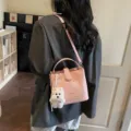 Pink lychee texture bucket bag with white dog plush charm and adjustable strap - Pendant Style / Pink