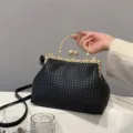 Elegant black woven leather handbag with gold frame and pearl clasp detail for women - Black