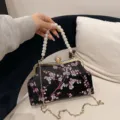 Elegant embroidered floral evening bag featuring a pearl handle and gold chain strap - Peach Blossom Embroidery Style / Black
