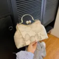 Elegant vintage shell handbag with floral embroidery, pearl clasp, and gold chain strap - Gold