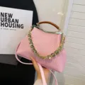 Elegant pink woven crossbody shell bag with wood-grain acrylic handle and gold chain - Pink