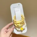 Gelbe elastische Haargummis Set mit Herz- und Perlenanhängern auf Display-Karte - 5er-Pack / Gelb
