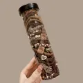 Set aus elastischen Haargummis in Erdtönen mit Herz- und Smiley-Symbolen in einer Tube. - 20 Stück/Packung / Dunkelbraun