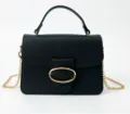 Detailed view of the elegant black textured handbag with golden circular buckle - Black