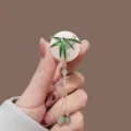 Close-up of elegant Chinese style jade ring brooch with green bamboo leaf and tassels - Green Bamboo (XZ25157)