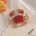 Detailed view of an alloy crab brooch inlaid with sparkling red and clear rhinestones. - XZ158 Crab (XZ158) / Red