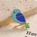 Close-up of a colorful blue bird enamel brooch with golden finish details - Blue Bird (XZ02-012) / Blue