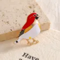 Close-up of a vibrant red and white enamel bird brooch with golden accents - Red Bird (XZ02-012) / Red
