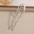 Close-up view of a minimalist silver wavy U-shaped hair fork for elegant updo styles. - Wave Style (F015) / 12.7x3.5cm / Silver