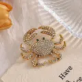 Detailed macro view of a sparkling gold alloy crab brooch with colorful rhinestones. - XZ158 Crab (XZ158) / AB Color