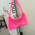 Detail of a vibrant neon pink transparent PVC underarm jelly bag with matching chunky chain strap - 24*6*17CM / Rose Red