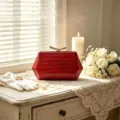Elegant red crocodile texture hexagonal evening clutch bag on a vintage dresser - Red