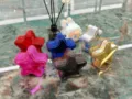 Close-up of star-shaped acrylic mini bags in various shiny metallic colors - Gunmetal