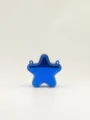 Detail shot of the glossy blue star-shaped acrylic mini crossbody handbag for women. - Blue