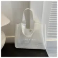 Λεπτομερής όψη διαφανούς τσάντας παραλίας PVC με εκτύπωση Tote Bag και μεταλλικό κουμπί - Λευκό