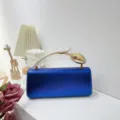 Elegant blue metallic textured evening clutch bag with unique golden floral handle detail. - Blue