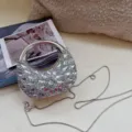 Nahaufnahme einer Mini-Abendtasche aus silbernen Strasssteinen mit schickem Metallgriff - 13*5*12cm / Silber Modell 1