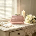 Detail of pink hexagonal crocodile pattern clutch bag in an elegant wedding scene setting - Pink