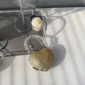 Close-up of heart-shaped mini evening bag with sparkling rhinestones and beaded handle - Gold Round Zircon