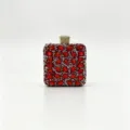 High-definition detail of a luxury red crystal-encrusted evening clutch with gold clasp - 12.5x7x15cm / Red