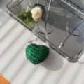Close-up of a luxury green heart-shaped rhinestone mini evening bag with crystal handle - Green Flat Rhinestone