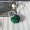 Detailed view of a green rhinestone heart-shaped mini lipstick bag with beaded strap - Green Round Rhinestone