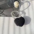 Detail of black heart-shaped rhinestone evening bag with clear beaded handle - Black Round Zirconia