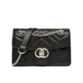 Chic black chevron quilted shoulder bag with gold chain strap and interlocking clasp - Black