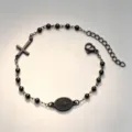 Detailed macro view of black stainless steel rosary bracelet with cross and religious medal - Priest Bracelet / Black