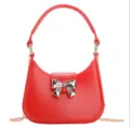 Stylish red PVC jelly underarm bag with silver bow detail and gold chain strap. - Red