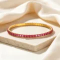 Close-up detail of a gold-plated stainless steel stretch bangle set with pink natural zircons - Rose Red Zirconia Bracelet / Rose Red