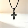 Macro detail of black stainless steel cross pendant with intricate engraved patterns - Black Cross + Rope Chain