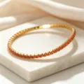 Elegant gold stainless steel elastic bracelet featuring square orange zircon crystals - Orange