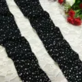 Detailed view of black mesh fishnet stockings sparkling with rhinestones on delicate lace. - One Size / Black
