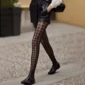 Detailed shot of trendy black patterned fishnet tights featuring chic floral lace design. - Houndstooth (BC-5109) / Simple Pack (White Card + OPP) / Black