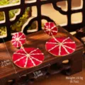 Detail view of Monet-inspired red enamel water lily earrings with size dimensions - Dark Red
