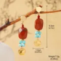 Detail view of ethnic style red stone earrings with turquoise beads and gold accents. - Red Brown Square Stone Style (2-30386-6500)
