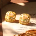 Close-up detail of French vintage style enamel gold earrings with natural white pearl - White Enamel Green Leaf (E4-21824B)