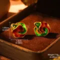 Macro view of vintage oil painting style rainbow enamel 3D stud earrings in a box. - Stereoscopic Twisted Flower Earrings (2-22248-5200)