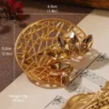 Detailed macro shot of a golden vintage flower brooch with faceted brown crystals - French Vintage Hollow Flower Style (BR1-1295E-7500)
