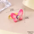 Detailed view of an adjustable gold ring with a pink butterfly and natural pearl. - Butterfly Design (1-4312-4500) / Open Adjustable / Pink