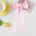 Detail of pink satin bow hair clip with central rose flower and long ribbons - Pink