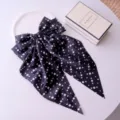 Macro detail view of black polka dot fabric hair bow clip with long silky ribbons - Black Polka Dot